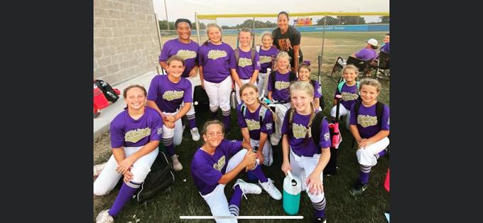 The Shiner Minor League softball team takes a photo with former University of Texas and US National Team pitcher Cat Ostermann. Photo courtesy of Yoakum Herald-Times. 
