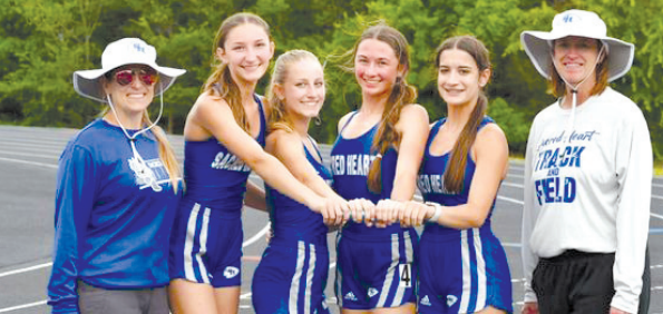 With coaches Jennifer Loudon, left and Wanda Orsak, are the three relay teams that won first in district. From left, Elena Grahmann, Katie Kostelnik, Bailey Haas and Aleigh Kraatz. Chuck Grafe/Tribune-Herald