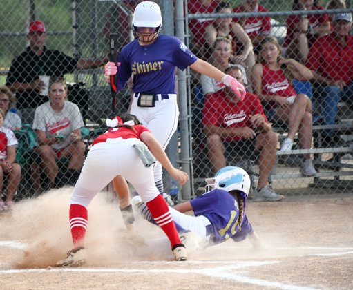 Shiner Major Softball’s Addison Ulcak slides into home plate in the first inning against Hallettsville Red on June 18. She scored the lone run for Shiner.   Photo by Mark Lube.