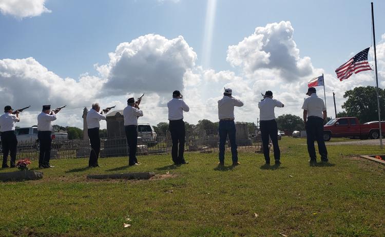 Members of Post No. 392 line up for a 21-gun salute and performance of TAPS beneath a half mast Memorial Day flag, lowered out of respect to the many lives lost last week in Uvalde.