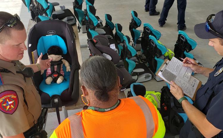 Shiner police, TxDOT, Texas DPS, Texas Agrilife Extension Service, emergency managent personnel and members of the Kaspar Foundatioin gathered at Green Dickson Park for the first-of-its-kind kids' car seat checkout.d 